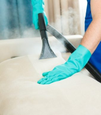 employee-cleaning-company-provides-chemical-steam-cleaning-service-sofa-steam-cleaner_156874-71